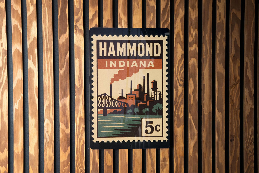A vintage-style stamp or poster with the text "HAMMOND INDIANA" and an illustration of a cityscape with a bridge and river.
