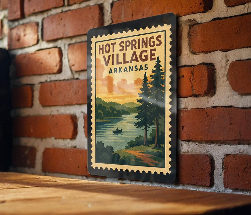 A vintage-style metal sign with the text "HOT SPRINGS VILLAGE ARKANSAS" displayed on a brick wall.
