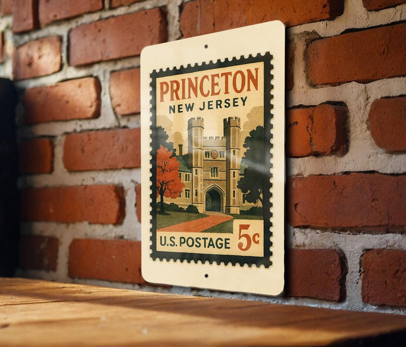 A vintage Princeton New Jersey postage stamp is displayed on a brick wall, with a wooden table below it.