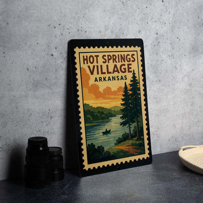 A framed poster of Hot Springs Village, Arkansas, featuring a scenic landscape with a lake, pine trees, and a boat on the water.