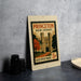 A Princeton New Jersey postage stamp is displayed on a table, featuring an illustration of the Princeton University campus.
