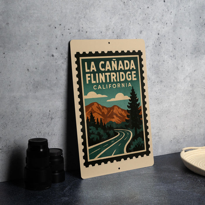 A framed poster of the scenic La Canada Flintridge in California, featuring a mountain landscape and a winding road.