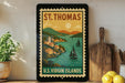 A framed vintage postage stamp depicting St. Thomas, the U.S. Virgin Islands, with a scenic coastal landscape and sailboats.