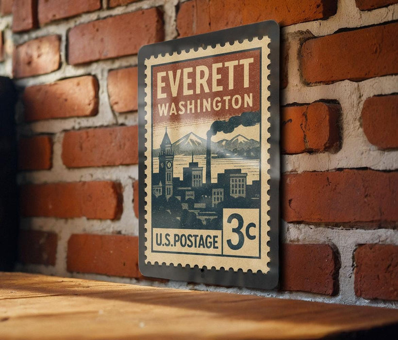 A vintage-style postage stamp from Everett, Washington, displayed on a brick wall.