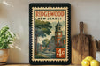 A framed poster of Ridgewood, New Jersey, featuring a clock tower and a street scene, is displayed on a shelf next to a wooden cutting board and some lemons.
