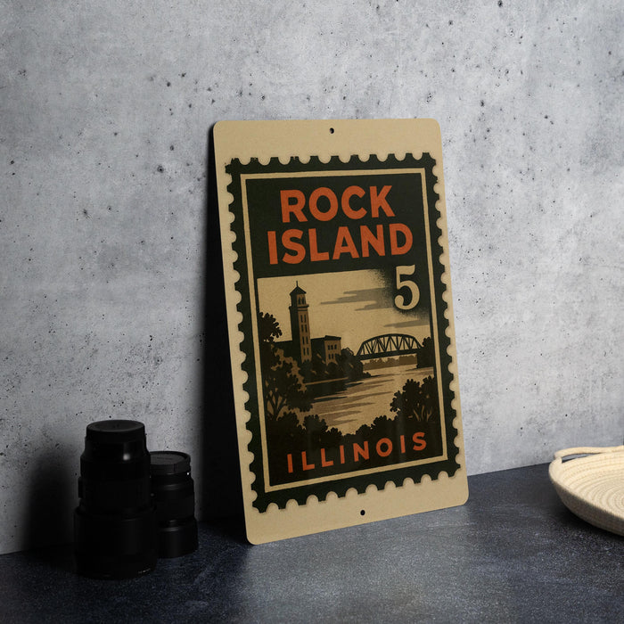 A vintage-style metal sign with the text "ROCK ISLAND 5 ILLINOIS" printed on it, standing on a gray surface next to some black camera lenses.