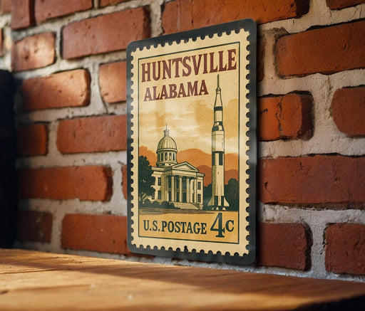 A vintage U.S. postage stamp depicting a building and a rocket ship, mounted on a brick wall.