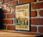 A vintage U.S. postage stamp depicting a building and a rocket ship, mounted on a brick wall.
