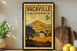 A framed vintage stamp depicting a rural landscape in Vacaville, California, with a farmhouse and mountains in the background.