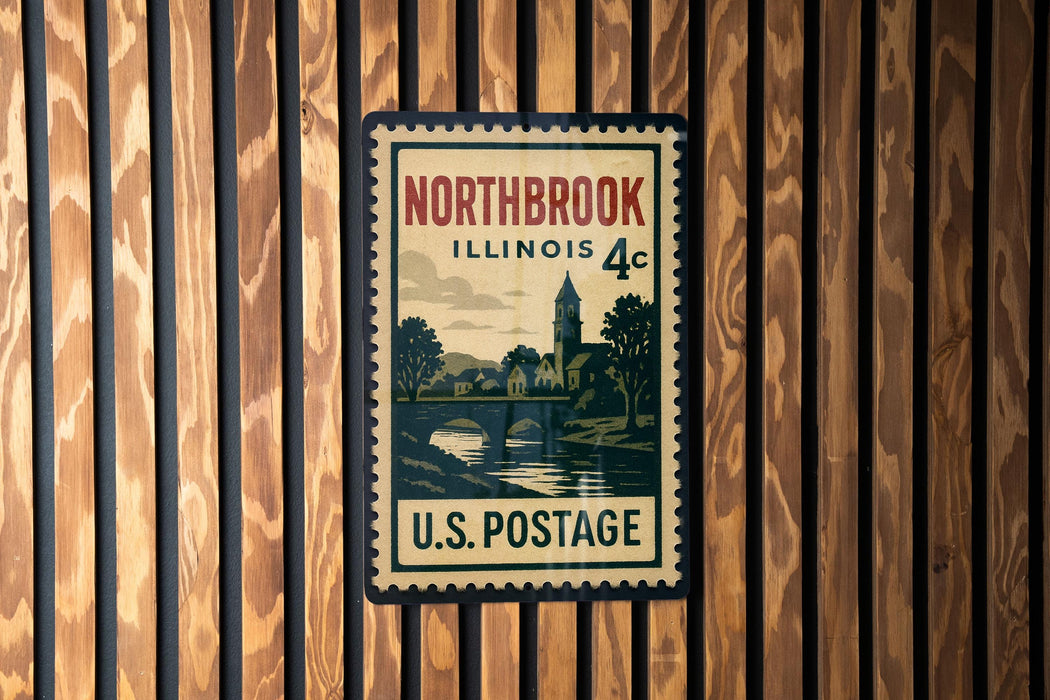 A vintage postage stamp from Illinois, featuring a scenic landscape with a bridge and trees, mounted on a wooden wall.