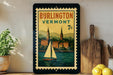 A vintage-style poster of Burlington, Vermont, featuring a sailboat on a river, is displayed on a wall next to a wooden cutting board and a potted plant.