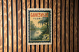 A vintage Florida postage stamp featuring a serene landscape of a river, palm trees, and a boat, mounted on a wooden wall.