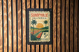 A vintage-style postage stamp from Sunnyvale, California, featuring a palm tree and a sunset landscape.