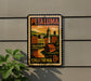 A vintage-style metal sign with a colorful illustration of a cityscape and a clock tower, mounted on a wall.