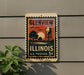 A vintage postage stamp from Illinois, featuring a water tower and a sunset, is displayed on a wall.
