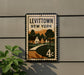 A sign for Levitown, New York, mounted on a wall.