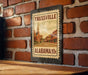 A metal sign with a vintage-style illustration of a church and a street in Trussville, Alabama, mounted on a brick wall.