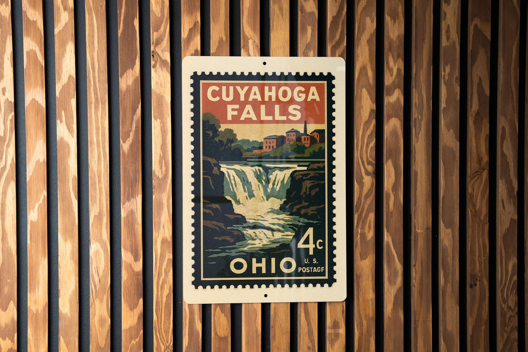A vintage postage stamp from Ohio featuring a waterfall and a building, mounted on a wooden wall.