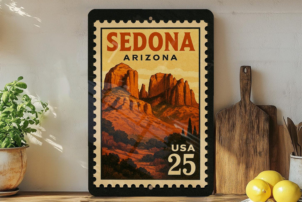 A framed vintage postage stamp depicting Sedona, Arizona, with the text "SEDONA ARIZONA" and "USA 25" printed on it. The stamp is displayed on a shelf next to a wooden cutting board and a potted plant.