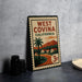 A vintage-style metal stamp with the text "WEST COVINA CALIFORNIA" and an illustration of a tropical landscape with palm trees and mountains.
