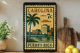 A vintage-style postage stamp from Carolina, featuring a palm tree and buildings, is displayed on a shelf next to a wooden cutting board and some lemons.