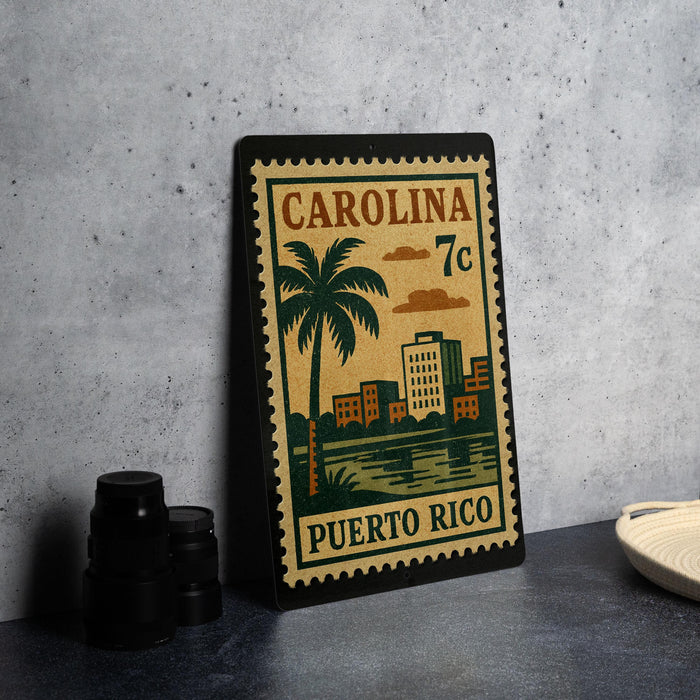 A metal stamp depicting a cityscape with a palm tree, surrounded by buildings, with the text "CAROLINA 7c PUERTO RICO" printed on it.