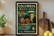 A vintage-style postage stamp from the United States, featuring a colorful illustration of a coastal town in Maryland.