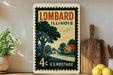 A vintage postage stamp from the United States, featuring an illustration of a rural landscape with a road and houses, placed on a wooden surface next to a wooden cutting board and some potted plants.