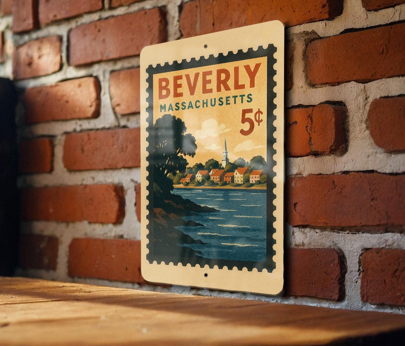 A vintage postage stamp from Beverly Massachusetts, featuring a scenic landscape with a river and houses, is displayed on a brick wall.