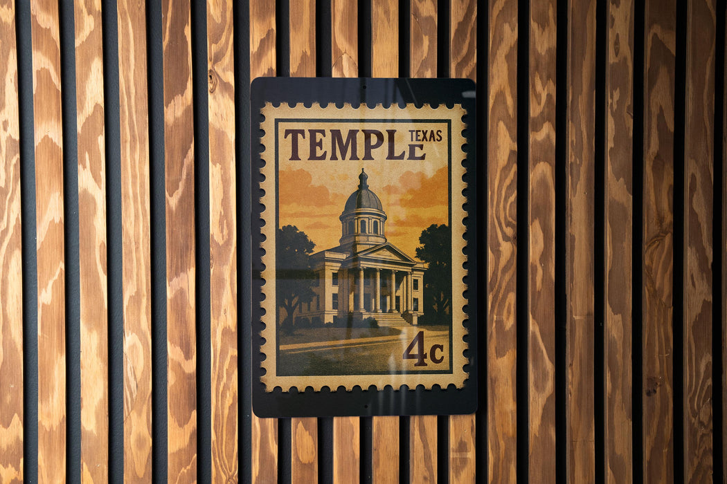 A framed image of a building, likely a historic landmark, is displayed on a wooden wall.