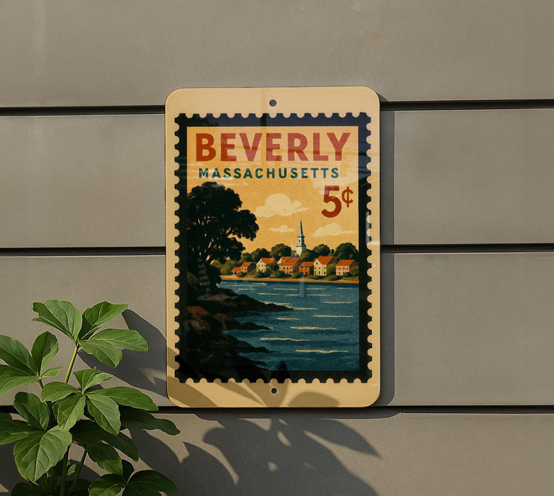 A vintage-style postage stamp from Beverly, Massachusetts, featuring a scenic landscape with a river and buildings, mounted on a wall.