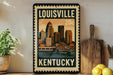 A vintage-style metal sign with the text "LOUISVILLE KENTUCKY" and an illustration of a city skyline.