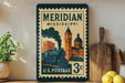 A vintage-style postage stamp from the United States, featuring an illustration of a train and buildings, is displayed on a shelf next to a wooden cutting board and some lemons.