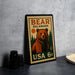A vintage-style metal stamp featuring a bear on a forest scene, with the text "BEAR DELAWARE USA 6c" printed on it.