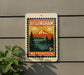 A vintage-style postage stamp from Washington, featuring a mountain landscape and a pine tree, is displayed on a wall.
