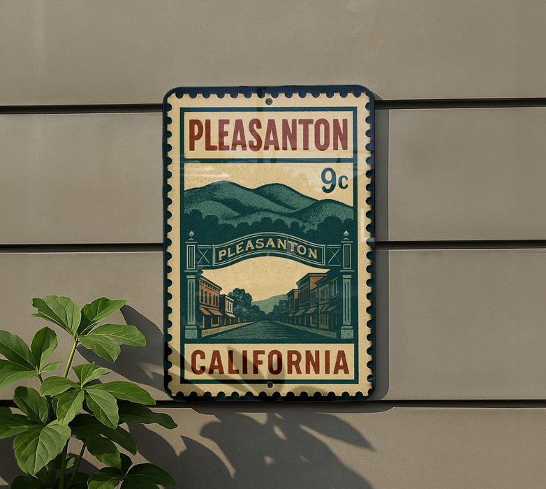 A vintage-style metal sign with the text "PLEASANTON 9c" and an illustration of a town, mounted on a wall next to a plant.