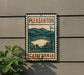 A vintage-style metal sign with the text "PLEASANTON 9c" and an illustration of a town, mounted on a wall next to a plant.