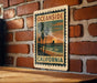 A vintage-style metal sign with the text "OCEAN SIDE CALIFORNIA" is displayed on a brick wall, featuring a sunset and palm trees.