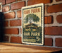 A vintage-style stamp depicting Oak Park, Illinois, with a house and tree, mounted on a brick wall.