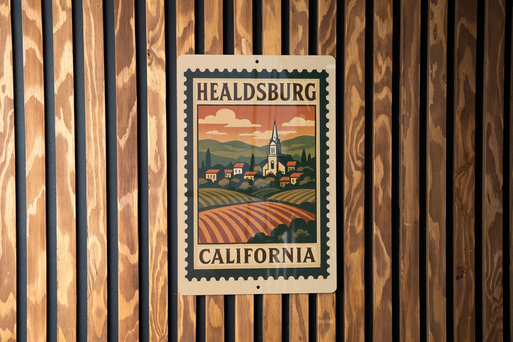 A metal sign with a vintage-style illustration of a town and countryside, mounted on a wooden wall.