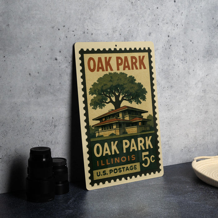 A vintage-style stamp depicting Oak Park, Illinois, with a house and tree illustration, placed on a gray surface next to some black camera lenses.