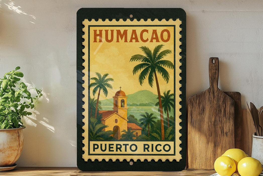 A framed vintage postage stamp depicting a tropical scene with palm trees and a church, hanging on a wall next to a wooden cutting board and a potted plant.