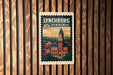 A vintage-style postage stamp depicting the city of Lynchburg, Virginia, with a clock tower and buildings in the background.