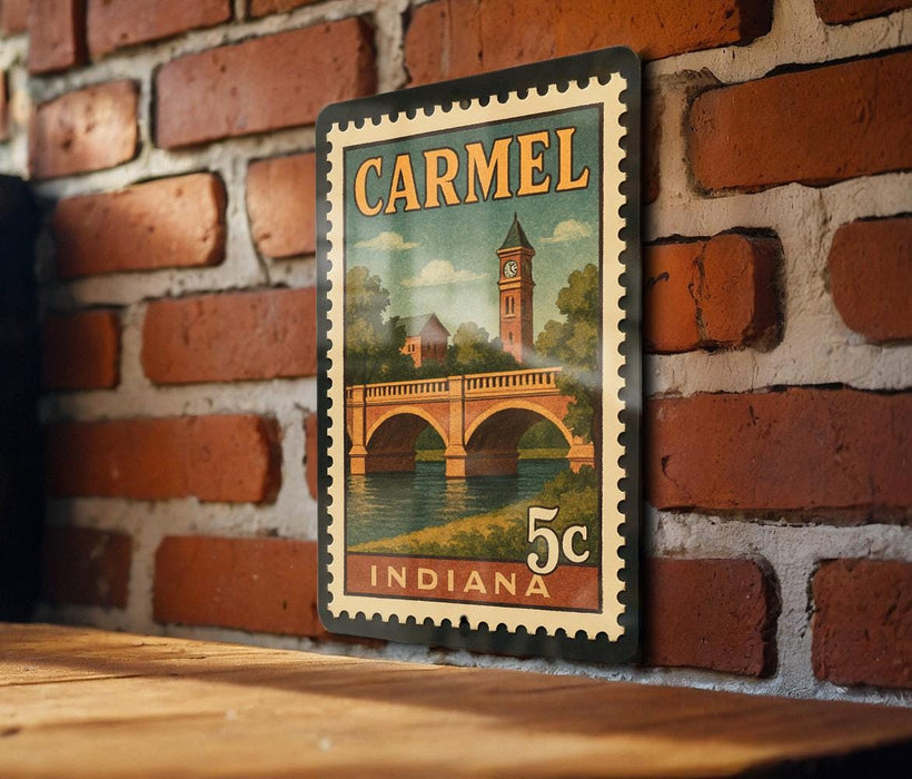 A vintage postage stamp from Indiana featuring a bridge and a clock tower, mounted on a brick wall.