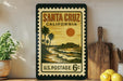 A vintage postage stamp from the United States, featuring a beach scene with palm trees and a pier, is displayed on a shelf next to a wooden cutting board and some lemons.
