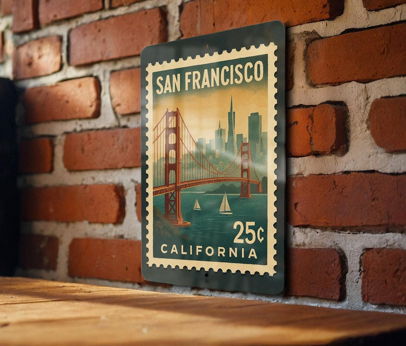 A vintage-style postage stamp from California, featuring the Golden Gate Bridge and the city of San Francisco, is displayed on a brick wall.