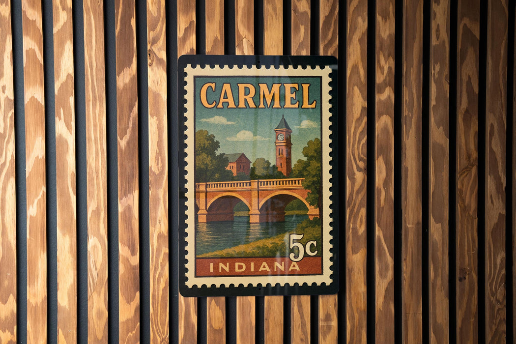 A vintage postage stamp from Indiana featuring a bridge and a clock tower, mounted on a wooden wall.