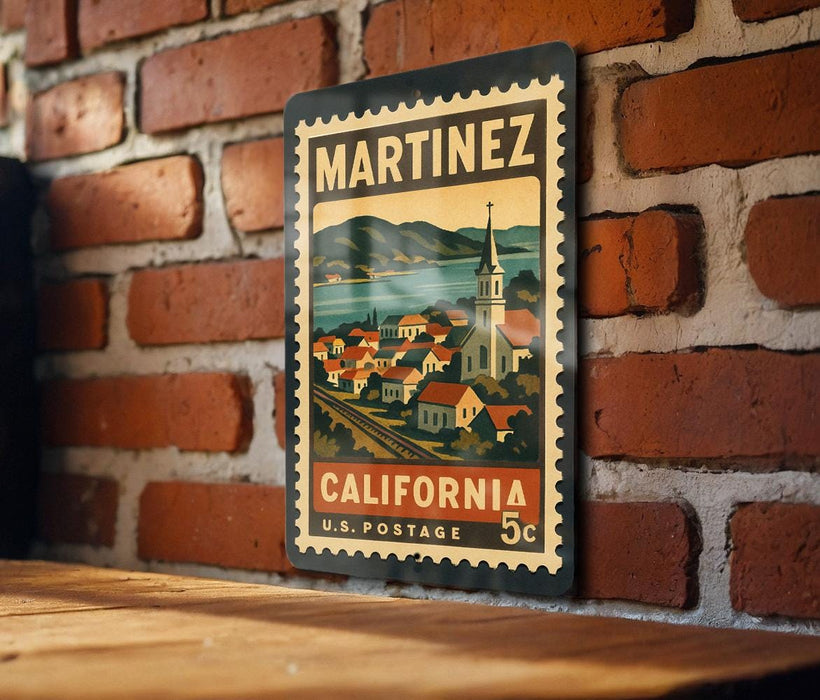 A vintage-style postage stamp from the United States, featuring a town scene with a church and mountains in the background.