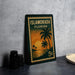 A vintage postage stamp from Florida, featuring a palm tree and sunset, is displayed on a table.