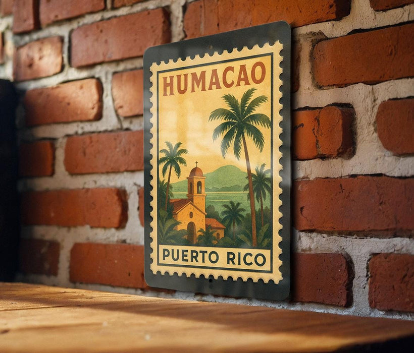 A metal sign with a tropical scene of palm trees and a church is hanging on a brick wall.